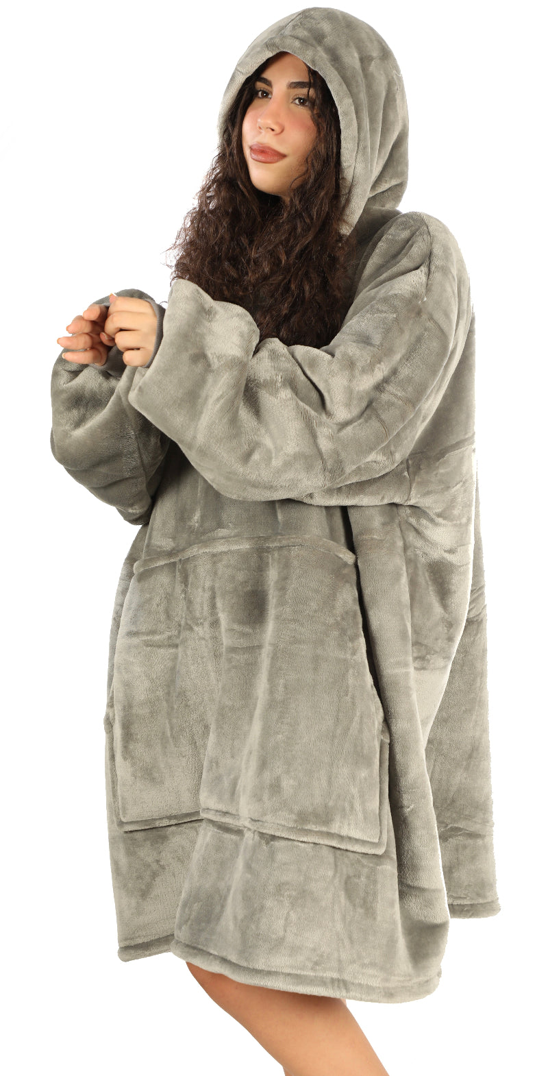 A woman standing sideways wearing a gray Cozify plush wearable blanket hoodie, showing the soft velvety texture and oversized cozy fit from the side view.