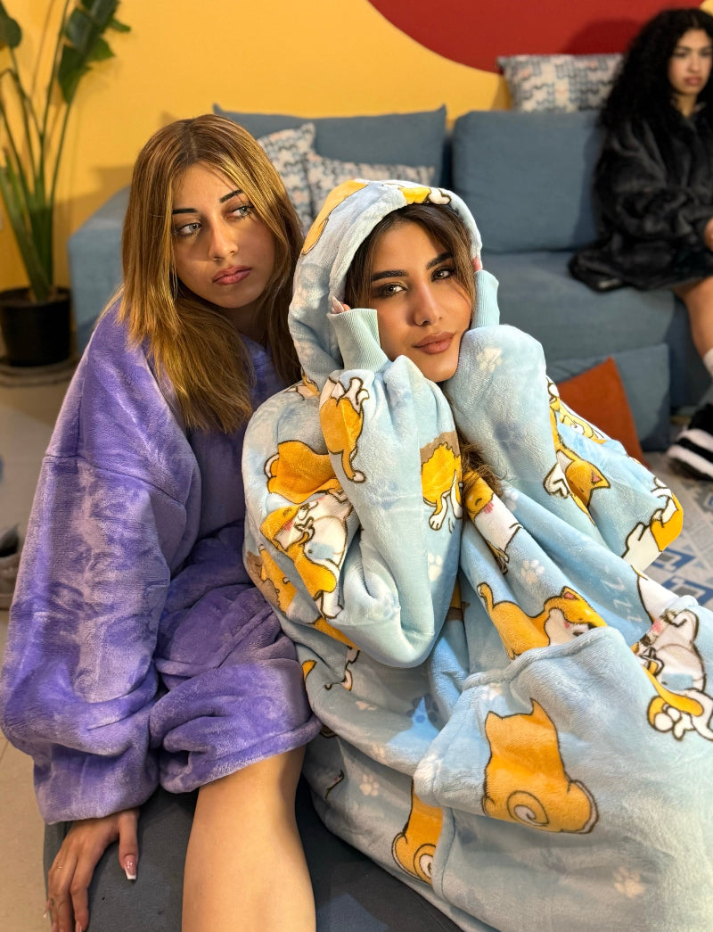 Two cozy wearable blanket hoodies with unique designs – oversized sherpa-lined hoodies featuring hood and front pocket, ideal for winter lounging, gifting or matching sets in Lebanon